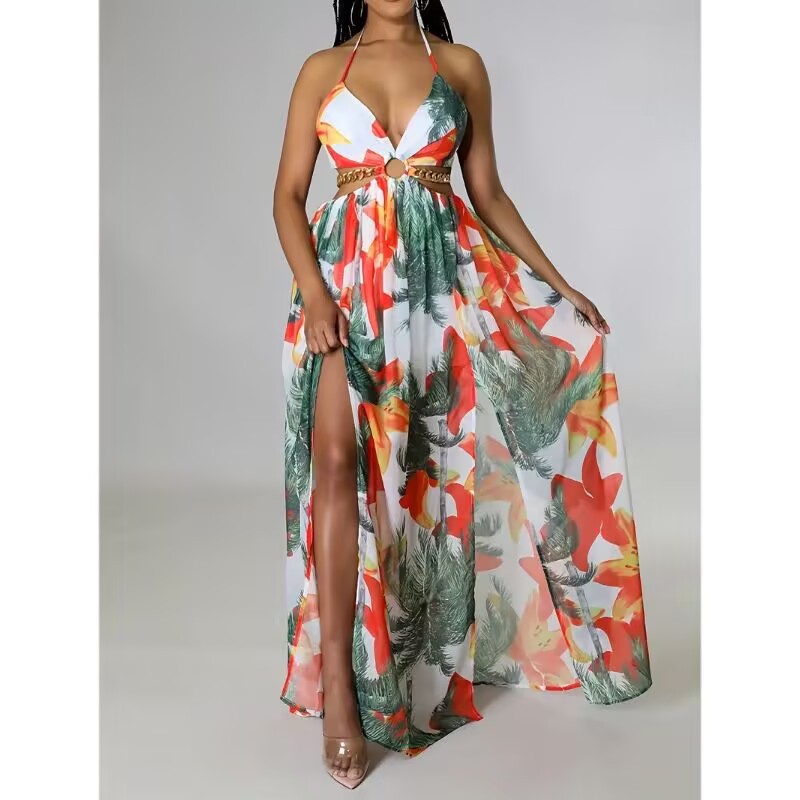 Woman wearing a colorful floral dress with a high slit on a gray background