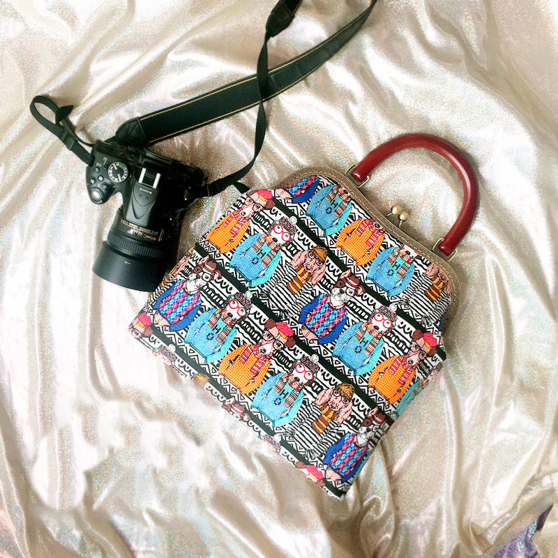 Colorful patterned handbag with a camera on a white fabric background