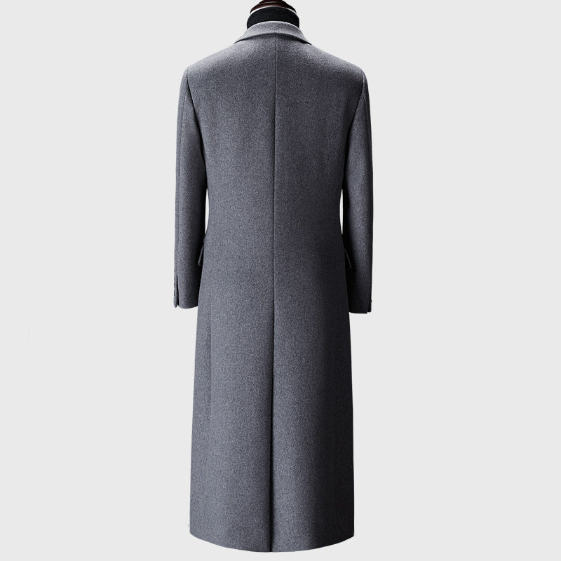 Gray overcoat on a mannequin against a white background