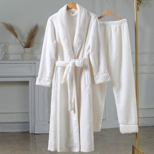 White textured bathrobe on a hanger against a neutral background