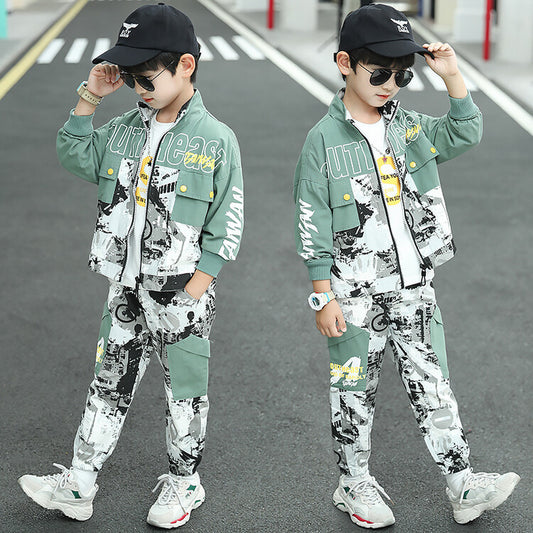 Two children in matching outfits walking on a road.
