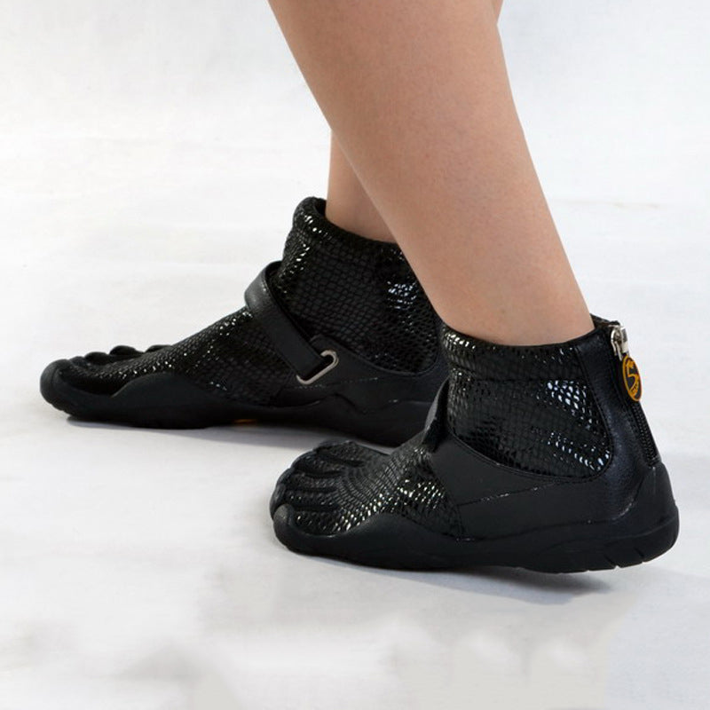 Black high-top shoes with unique sole design on a white background
