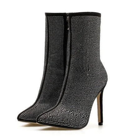 Black stiletto heel ankle boots with rhinestone detailing on a white background