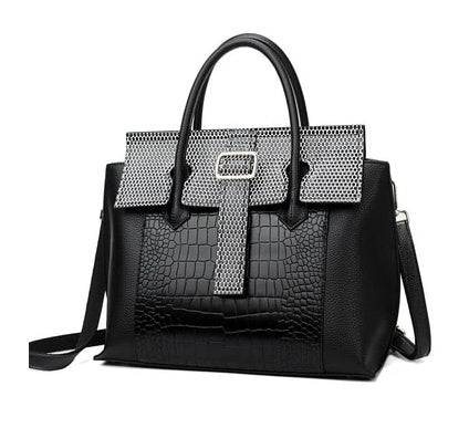 Black handbag with silver embellishments on a white background