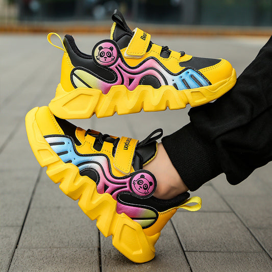 Colorful children's sneakers with cartoon character design on a pavement background