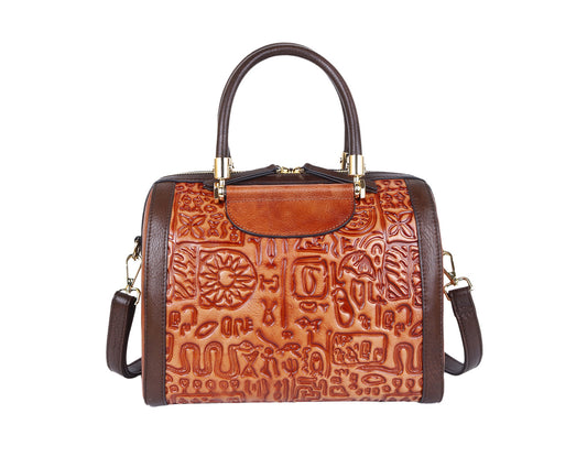 Brown leather handbag with intricate patterns on a white background