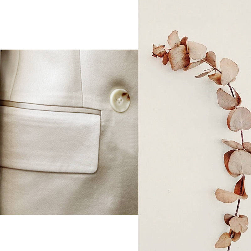 Close-up of a beige fabric texture with a button and a branch of dried flowers on a light background. by millivan