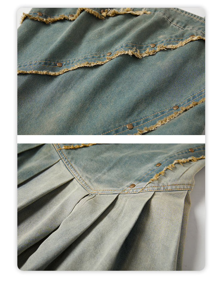 Close-up of a denim fabric with frayed edges and button details.