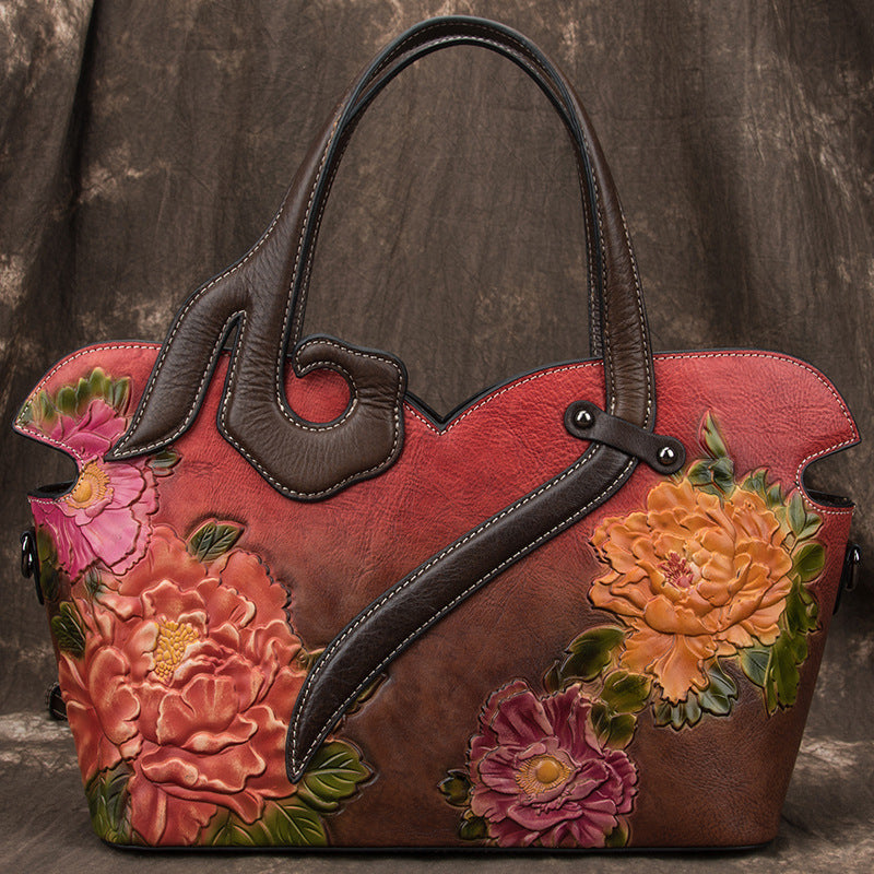 Handbag with floral designs on a textured brown background