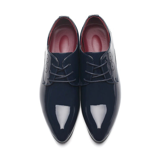 Pair of navy blue dress shoes with red interior on a white background