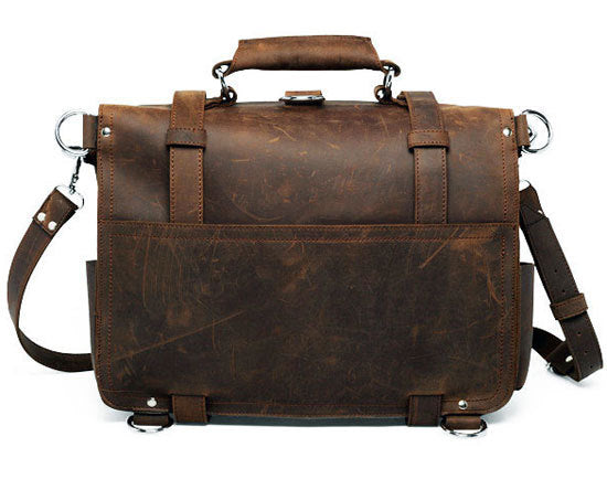 Brown leather briefcase with shoulder strap on a white background