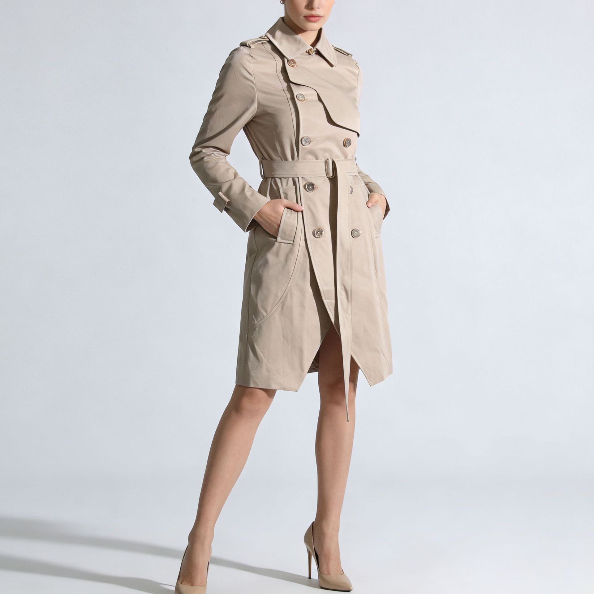 Woman wearing a beige trench coat on a light gray background by millivan