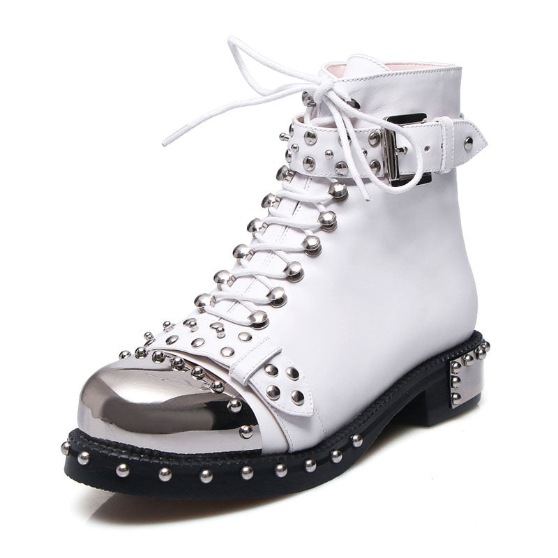 White boot with silver studs and a metallic sole on a white background