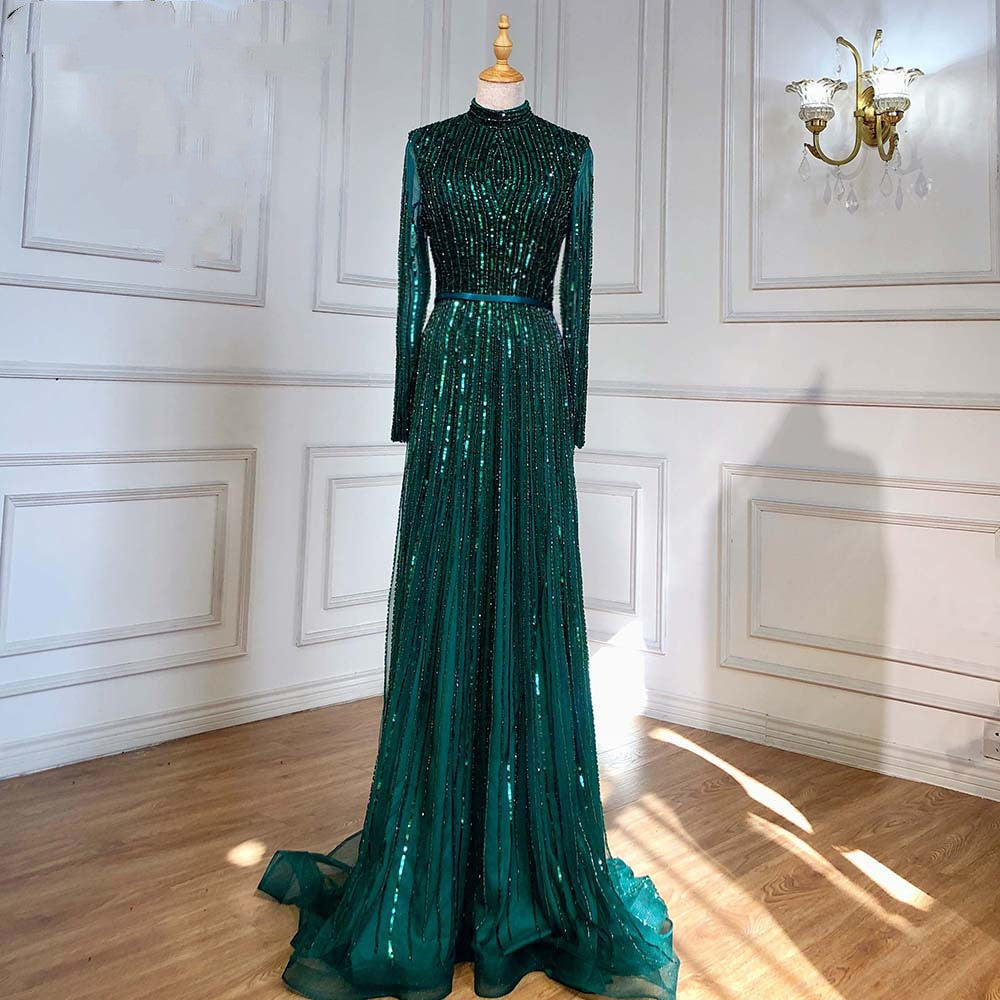 Green sequin evening gown on a mannequin against a white wall.
