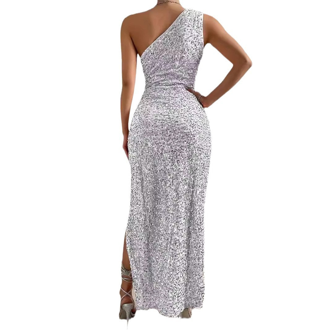 Woman wearing a silver floral one-shoulder dress on a white background