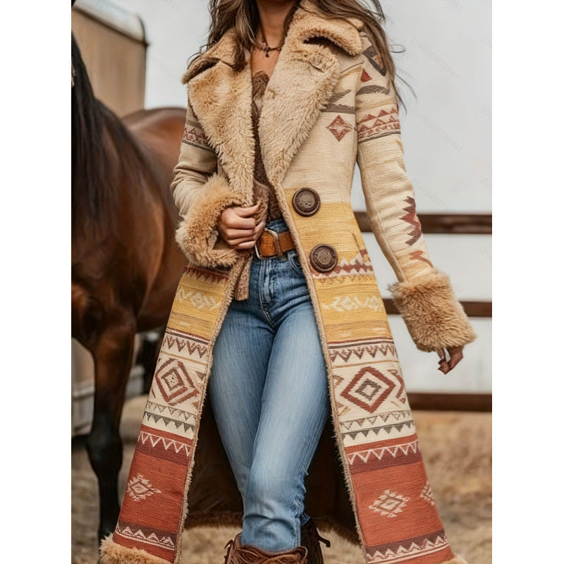 A woman wearing a long sherpa-lined coat with a Southwestern geometric pattern in beige, brown, and rust orange, paired with blue jeans and brown boots, standing in front of a horse.