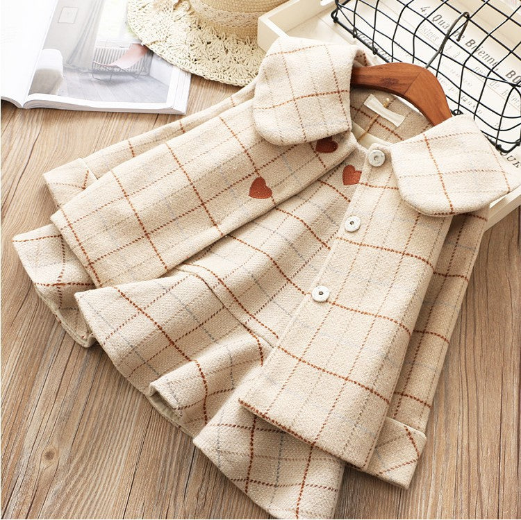 Beige plaid shirt with heart patterns on a wooden surface