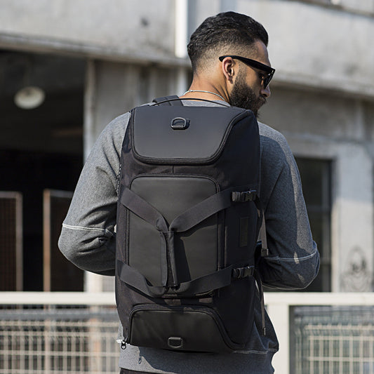 Man wearing a black backpack in an urban setting