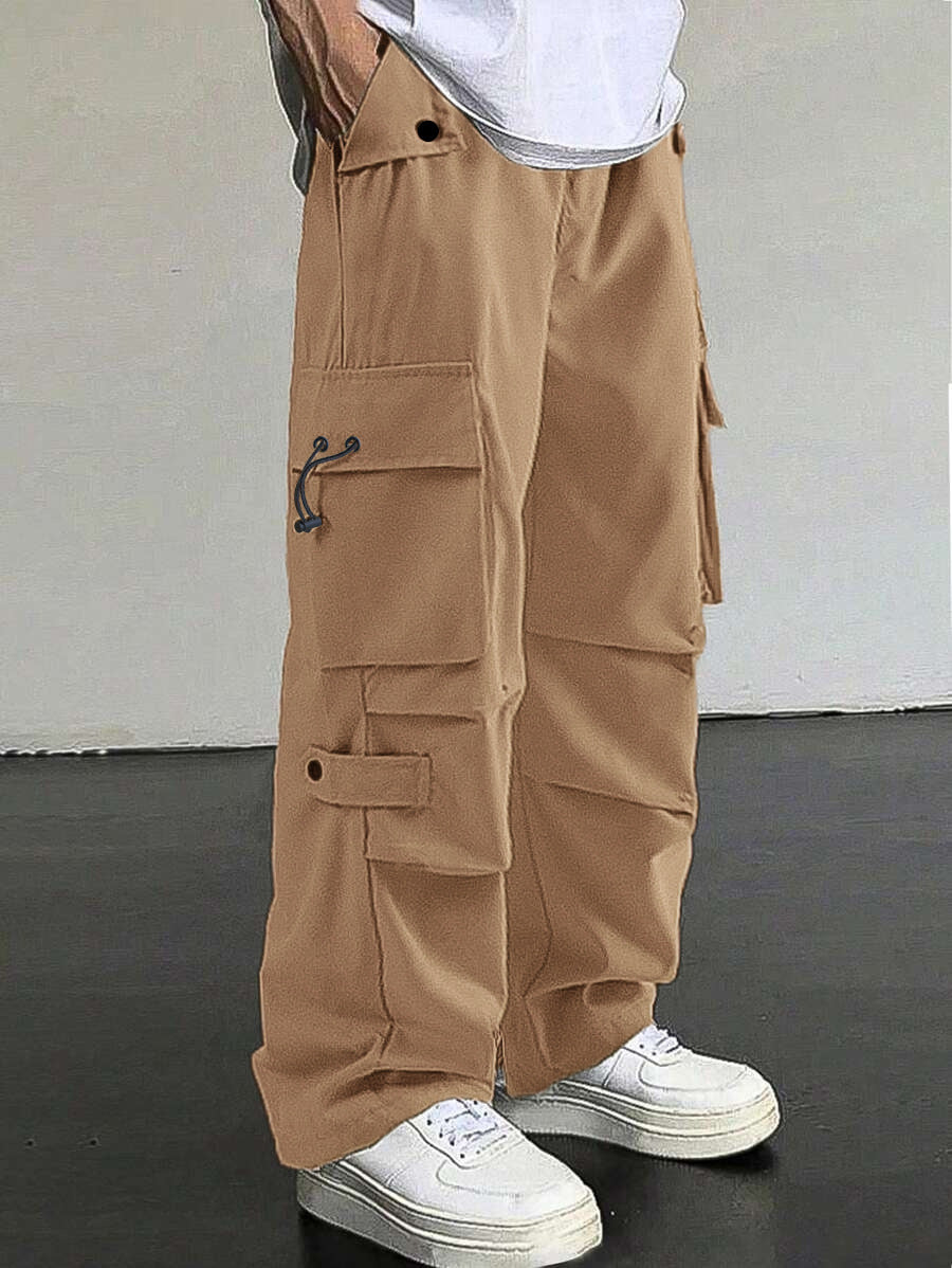 Person wearing beige cargo pants with a plain background