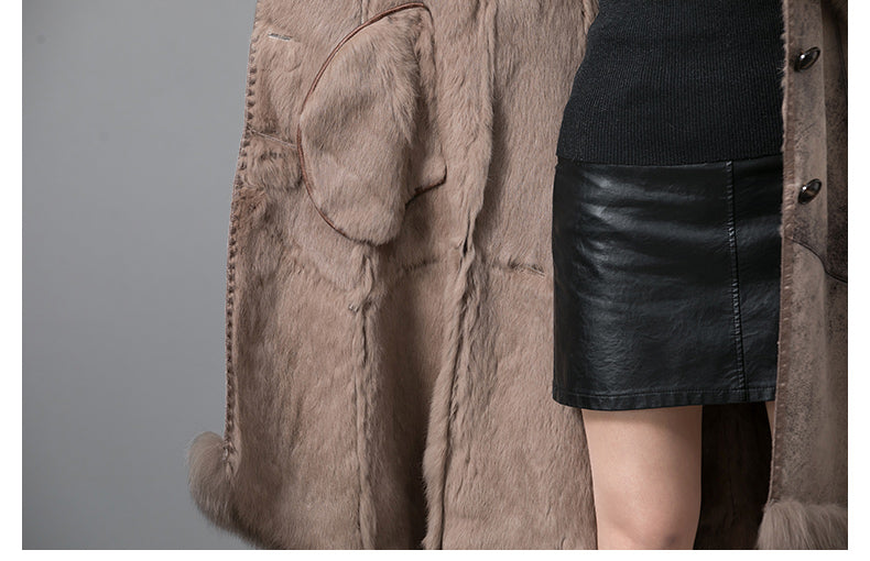 Brown fur coat with a black leather skirt on a gray background