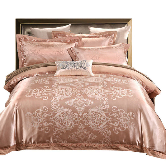 Pink and brown patterned bedding set with decorative pillows on a bed.