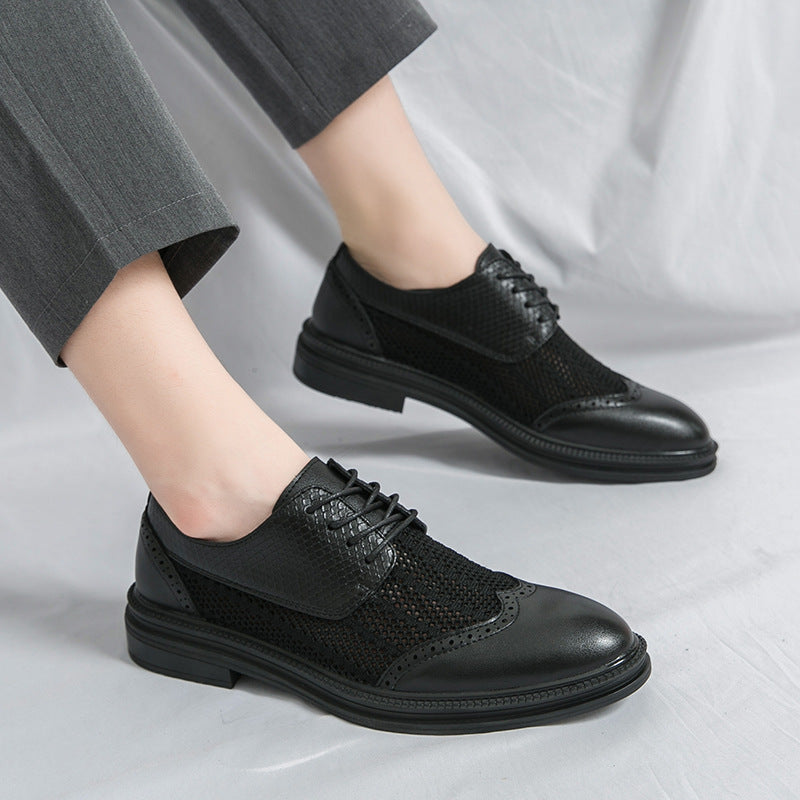 Black dress shoes worn with gray pants on a light gray background
