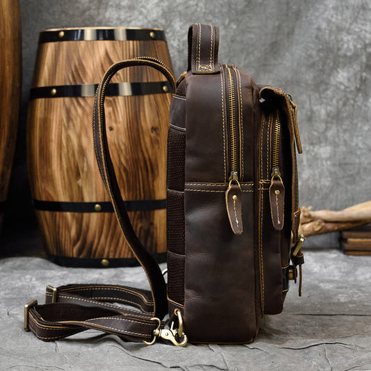 Brown leather bag with a wooden barrel in the background