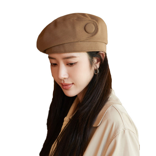 Woman wearing a brown beret on a white background