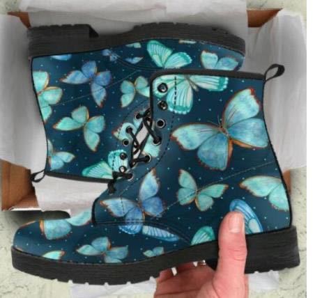 Blue butterfly-patterned boots held in a box