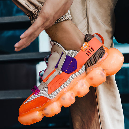 Close-up of a person wearing a sneaker with an orange sole and colorful accents.