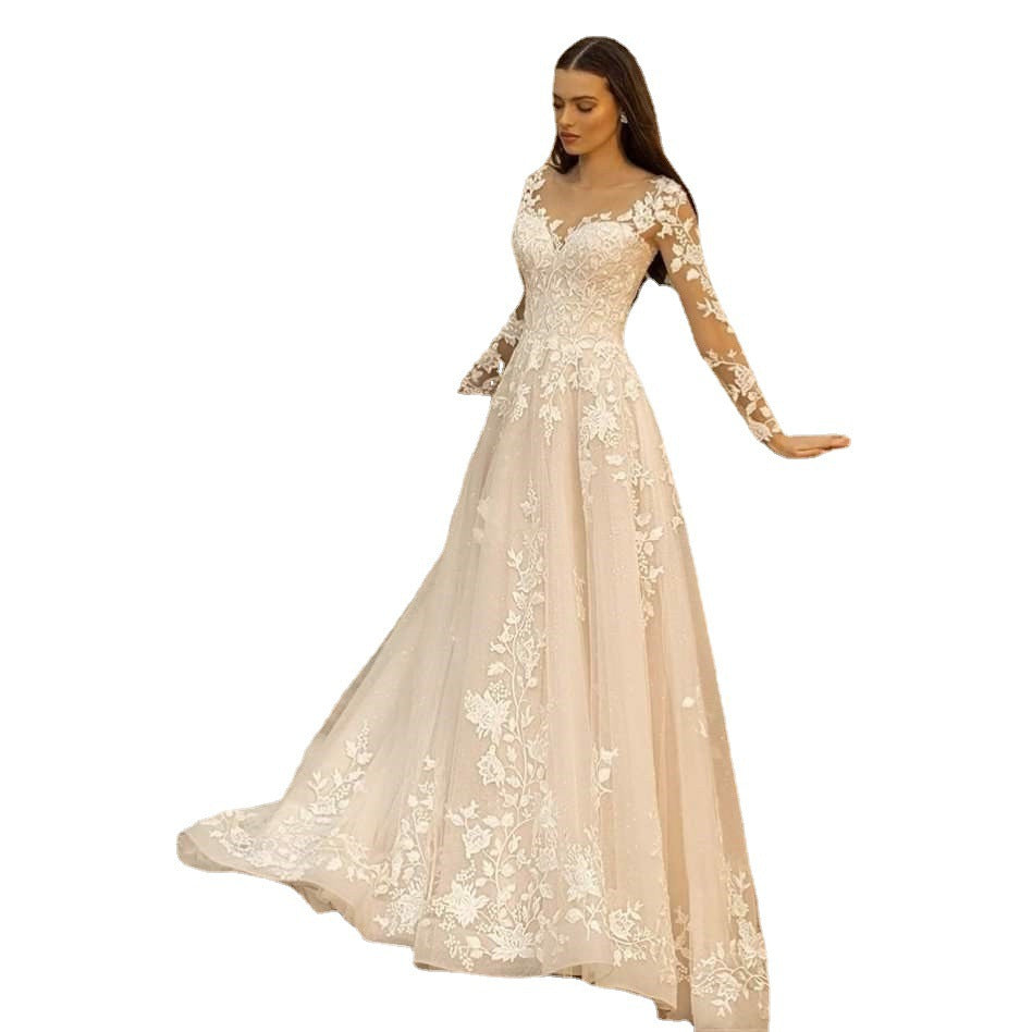 Woman wearing a beige lace evening gown on a white background