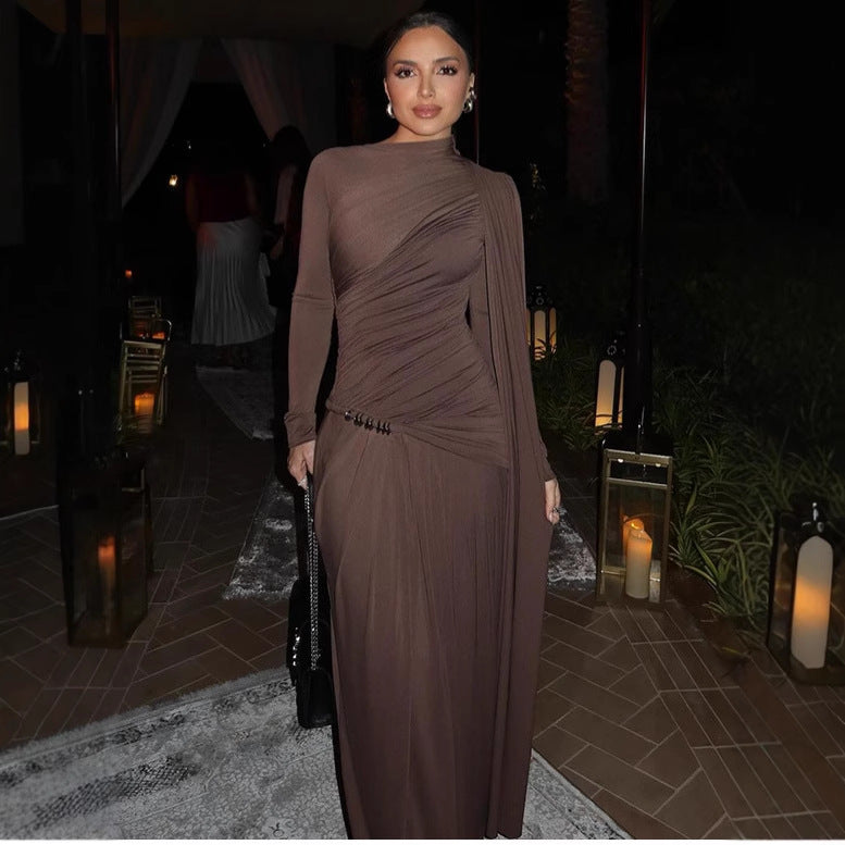 Woman in a brown dress standing in an outdoor setting with candles and lanterns.