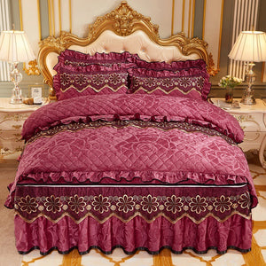 Purple bedspread with gold embroidery on a bed in a decorated room.