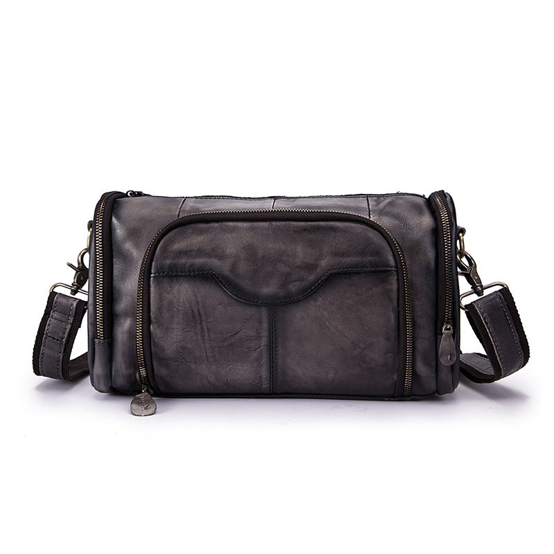 Black leather bag with multiple zippers on a white background