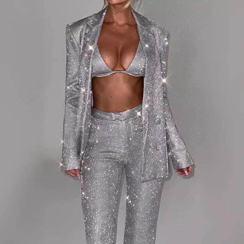 Silver glittery suit on a plain background