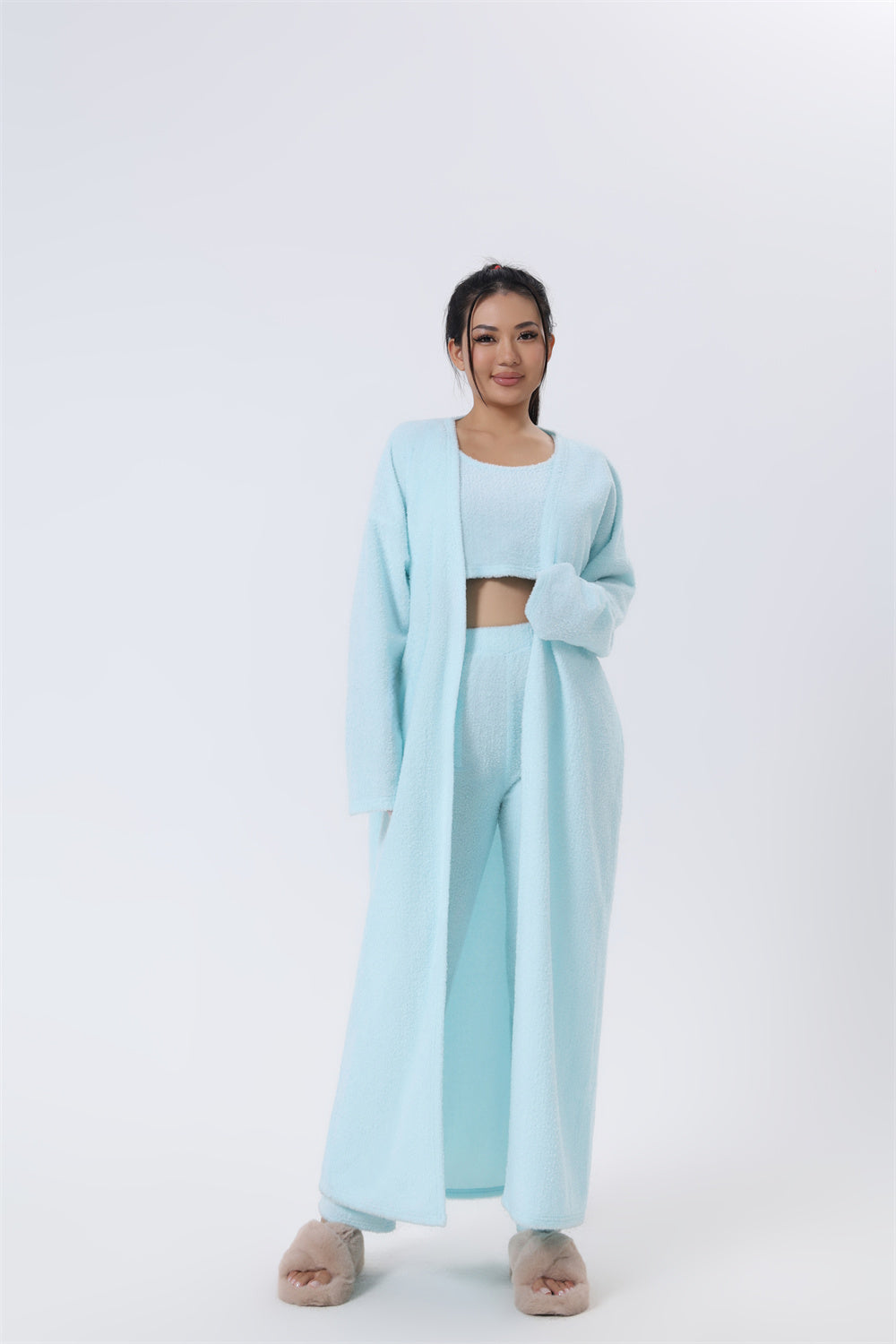 Woman wearing a light blue outfit on a white background