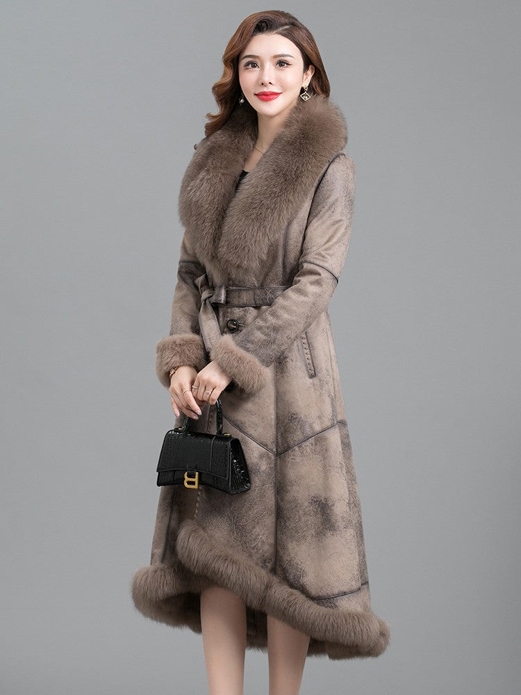 Woman wearing a long fur coat with a gray background
