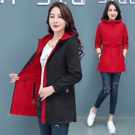 Woman wearing a red and black jacket with a gray background