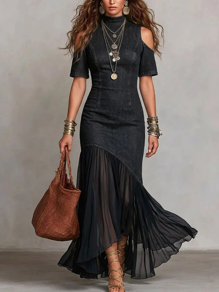 Woman wearing a black dress with a sheer overlay, holding a brown bag against a neutral background by millivan
