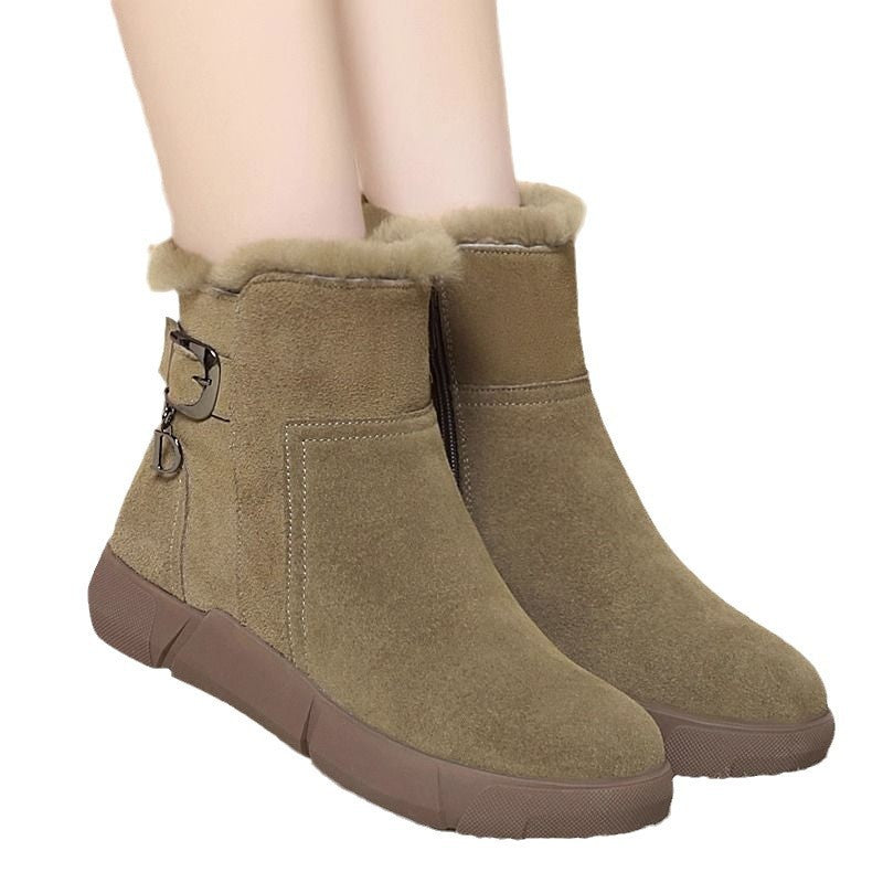 Pair of brown suede ankle boots with fur lining on a white background