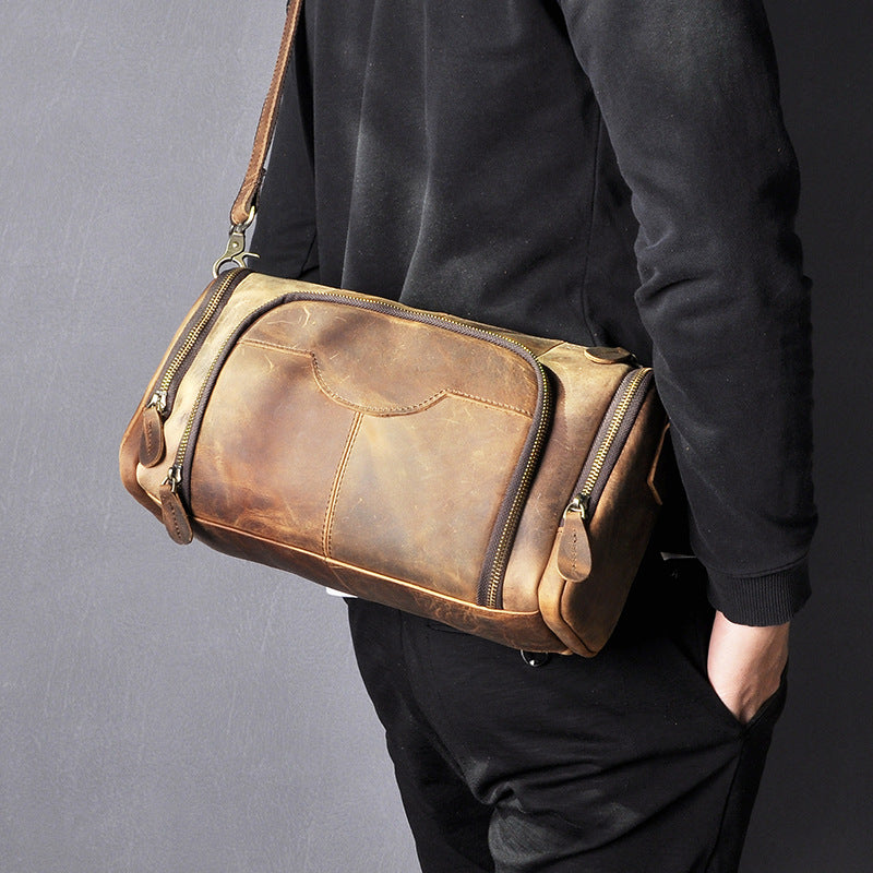 Person wearing a brown leather bag on a gray background