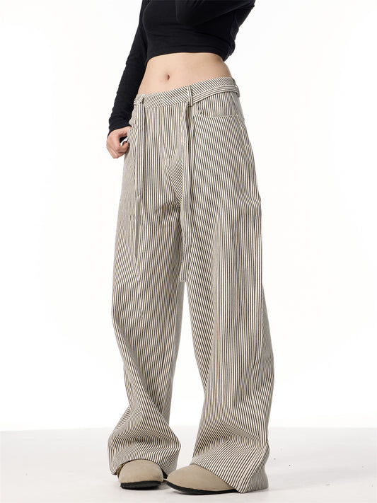 Person wearing wide-leg striped pants on a white background