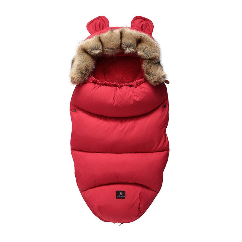 Red baby sleeping bag with brown fur trim on a white background