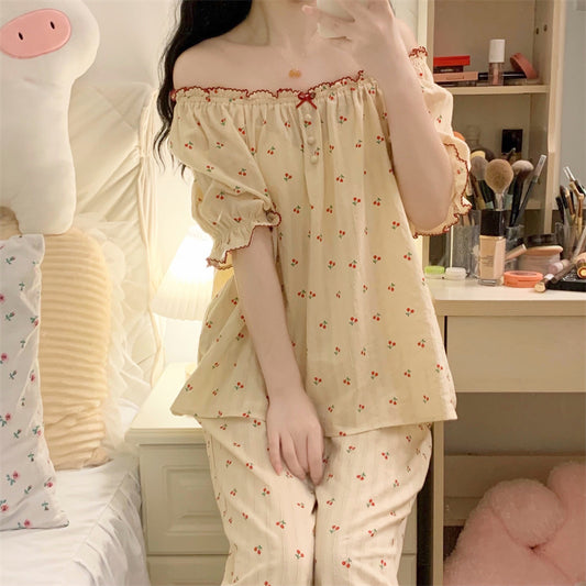 Person wearing a floral pajama set in a bedroom setting.