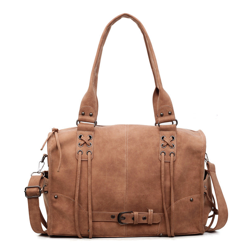 Brown leather bag with straps on a white background