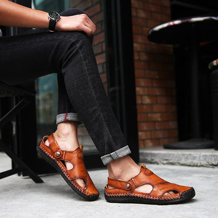 Person wearing brown leather sandals with a casual setting.