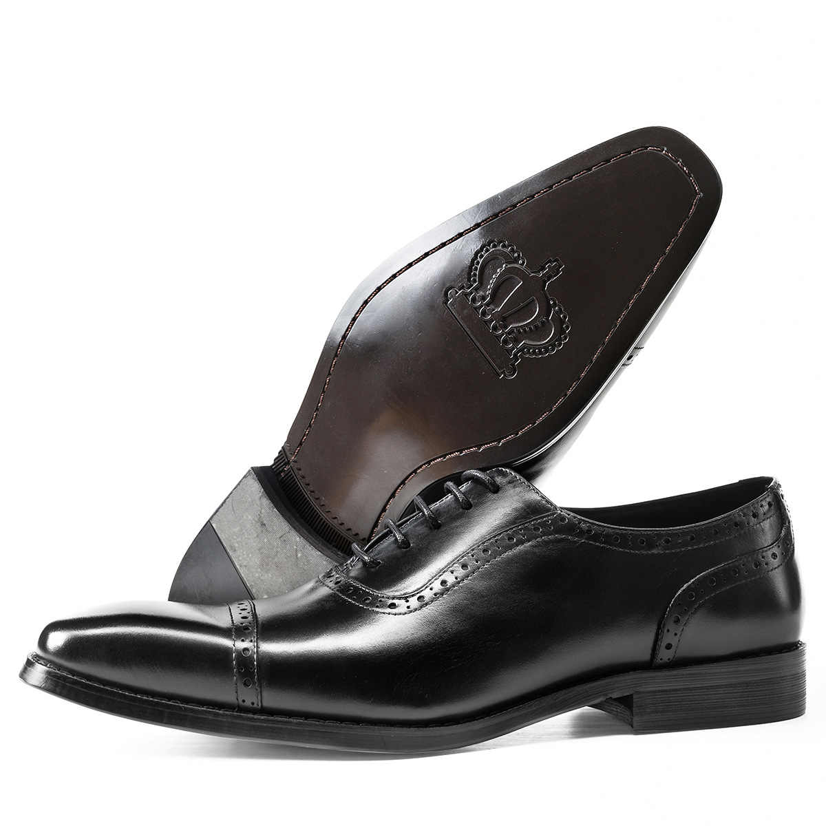 Black leather dress shoe with gray insole on a white background