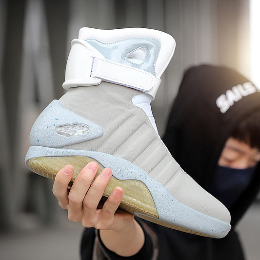 Light gray and white sneaker held by a person with a blurred background