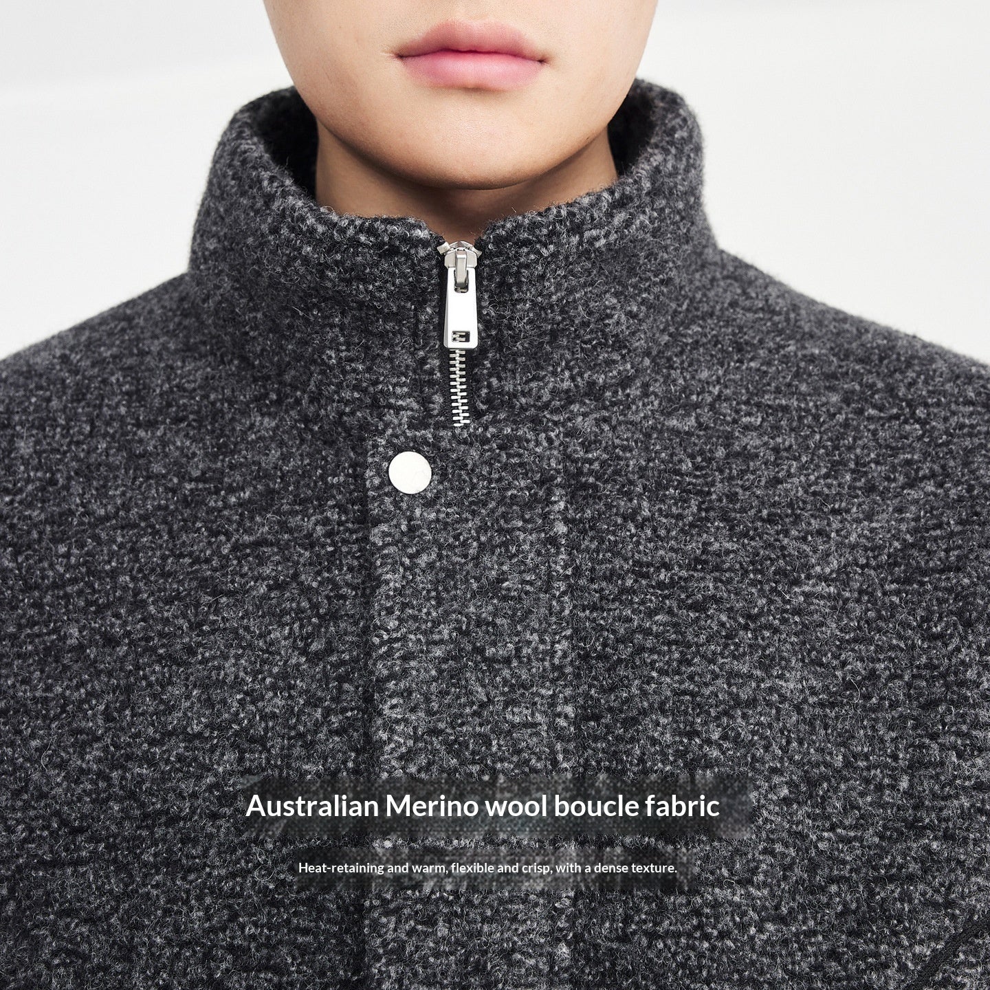 Close-up of a person wearing a gray textured jacket with text about Australian Merino wool boucle fabric.