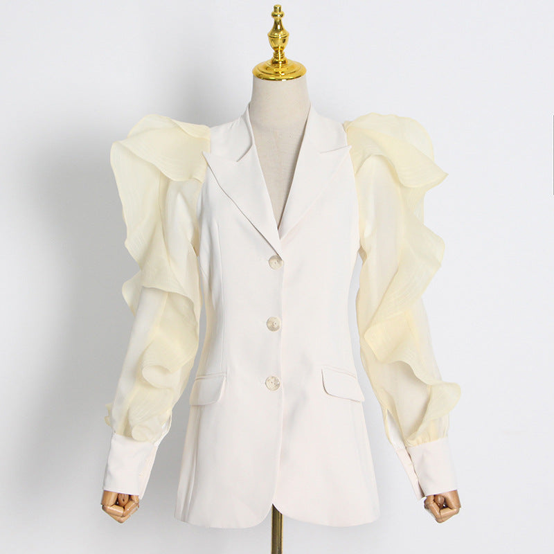 White blazer with ruffled sleeves on a mannequin against a white background